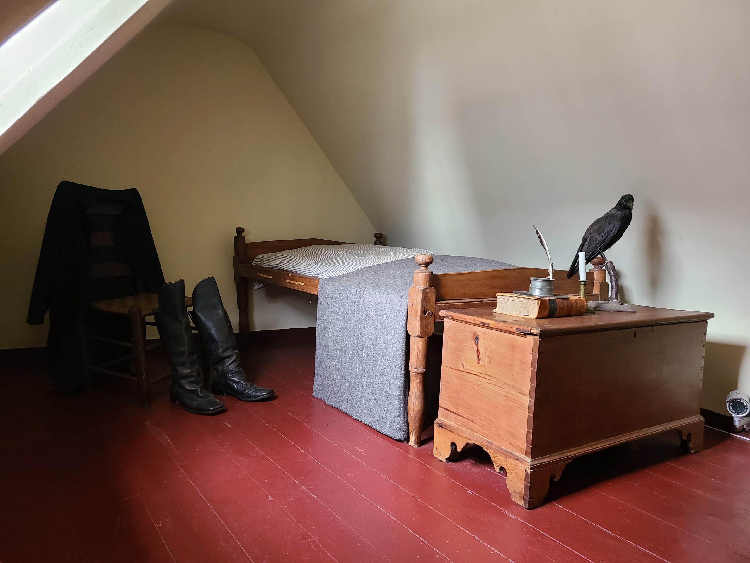 The attic bedroom in the Edgar Allan Poe house, decorated with simple furniture