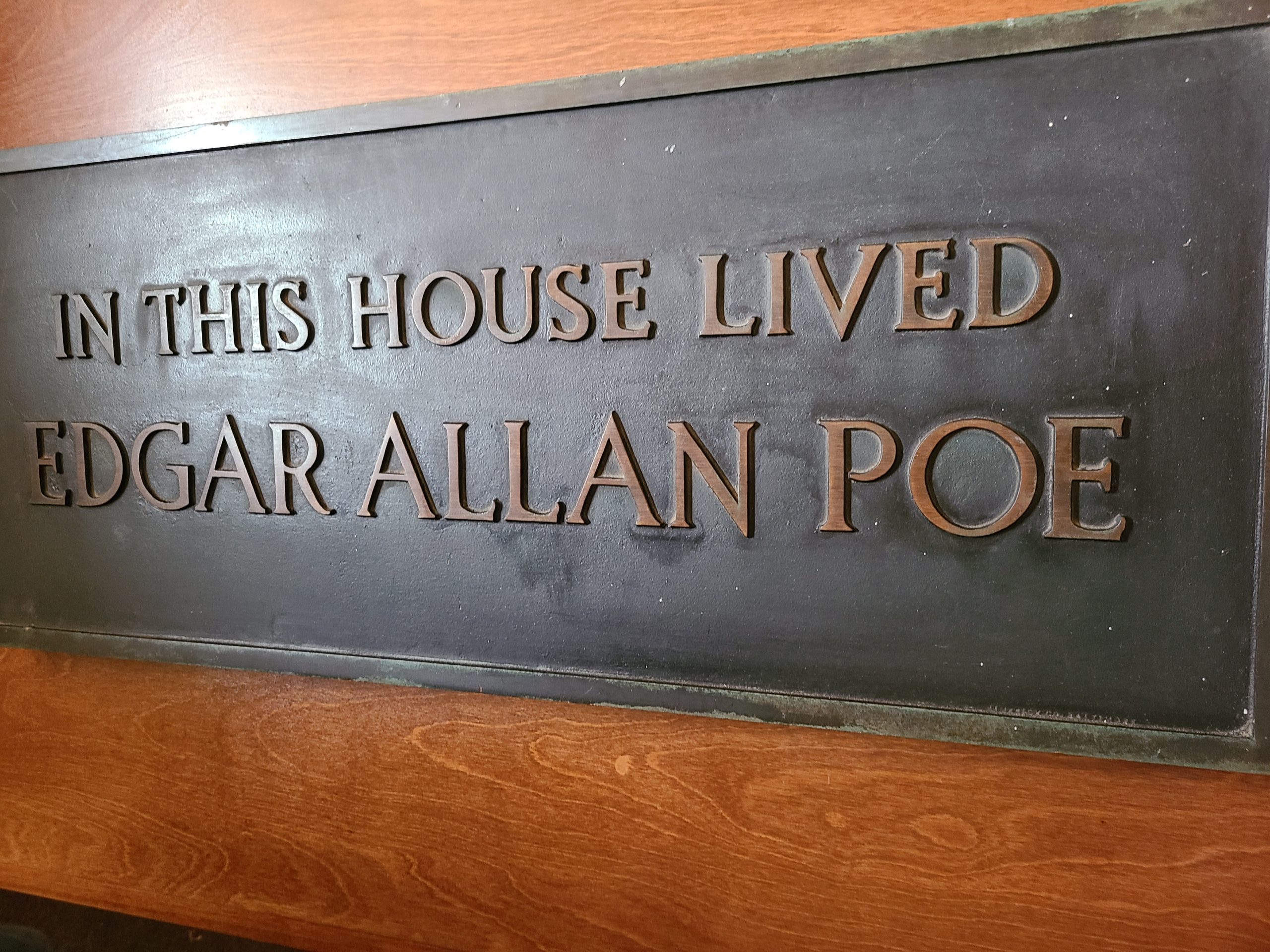 A metal plaque declaring that this is the Edgar Allan Poe house
