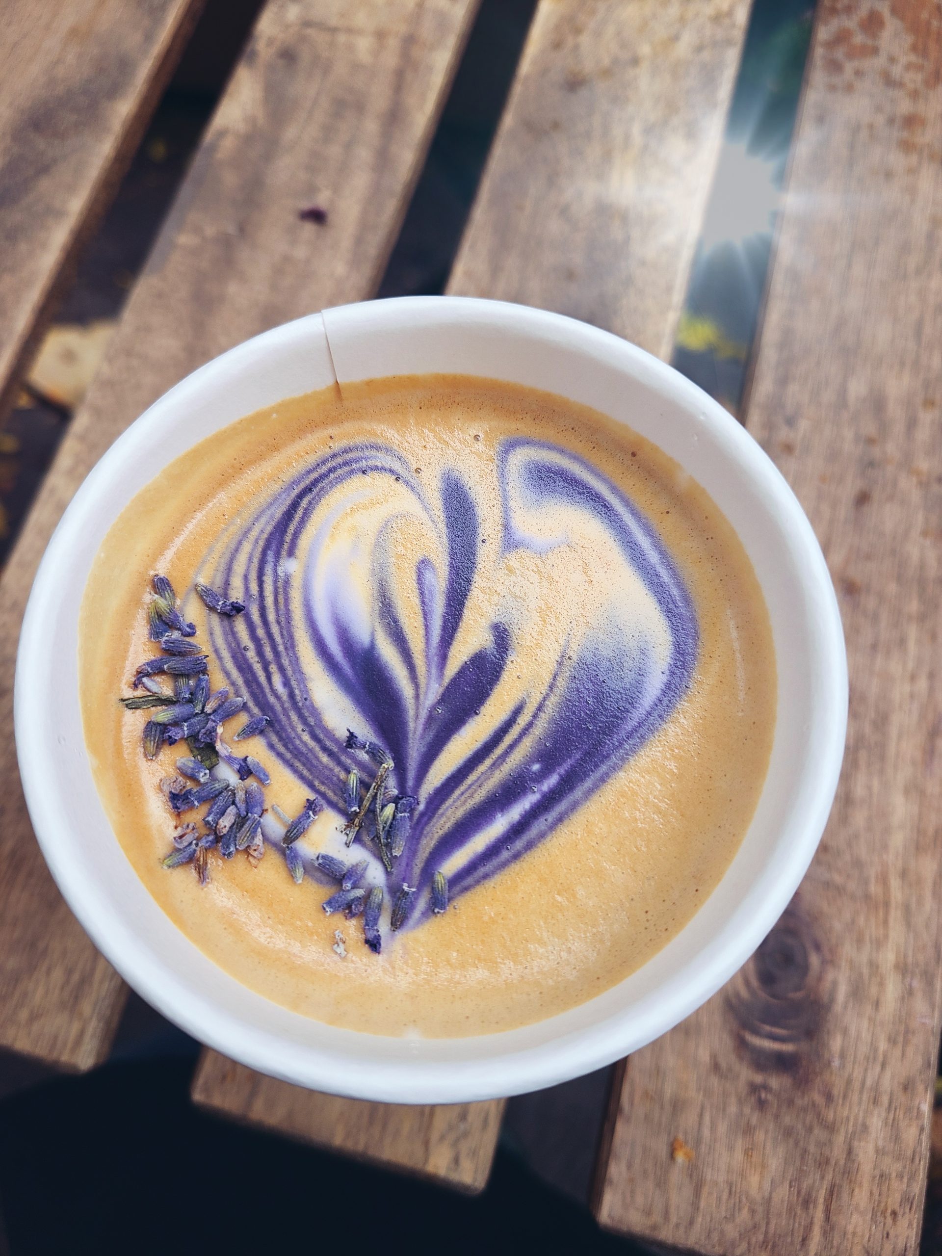 A close up of the purple latte art of a lavender latte.