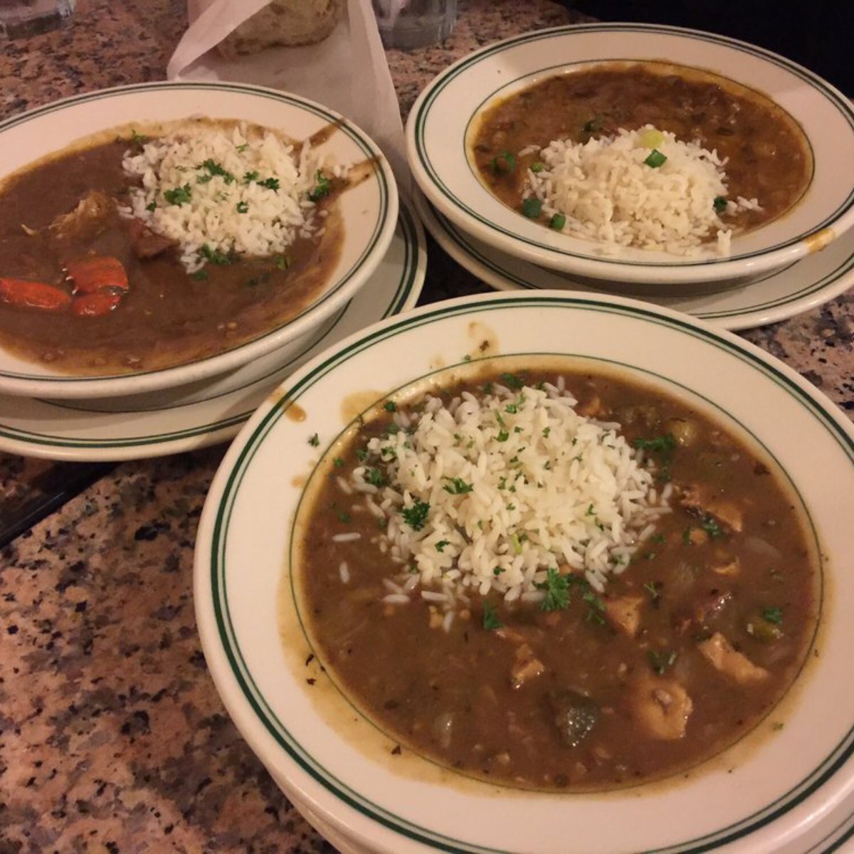 Three bowls of gumbo and rice