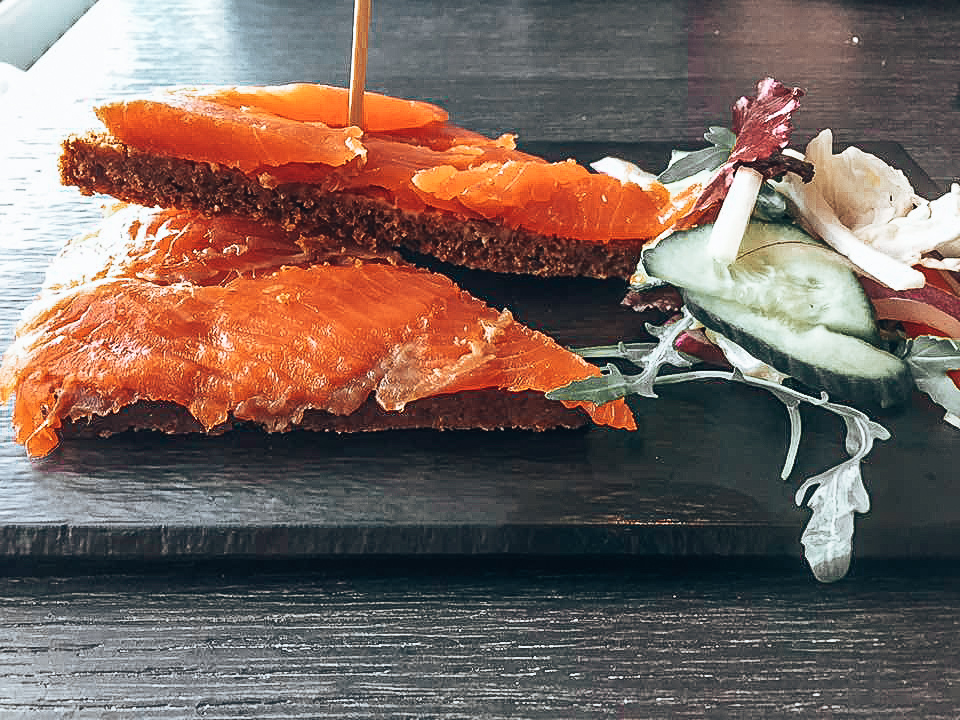 A tray of smoked trout on rye bread