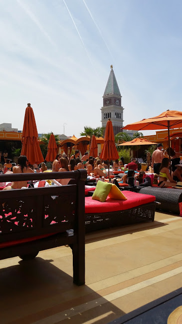 People sitting on day beds under umbrellas at the Tao Beach Club in Vegas