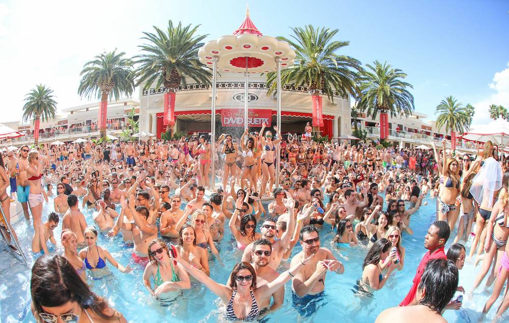 A crowd of people in a pool at the Encore beach club