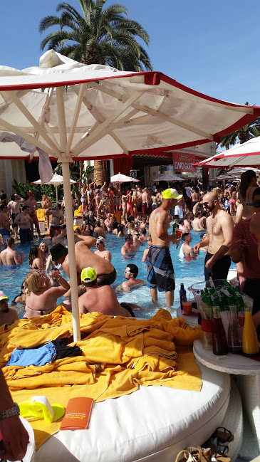 A group of people gathering in and around a pool