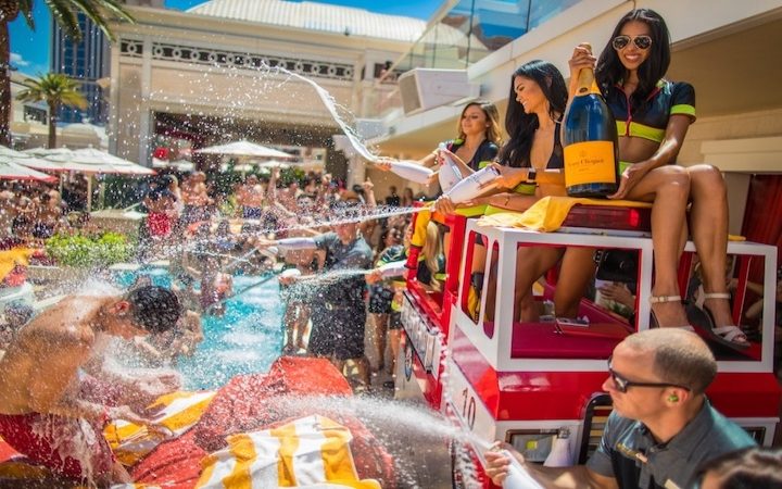 Are Vegas pool parties worth it? Crowds of people gather in a pool while people spray water at them
