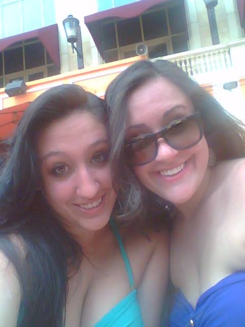 Two women pose for a photo at a Vegas pool party