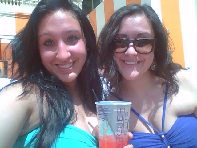 Two women pose for a photo at a Vegas pool party