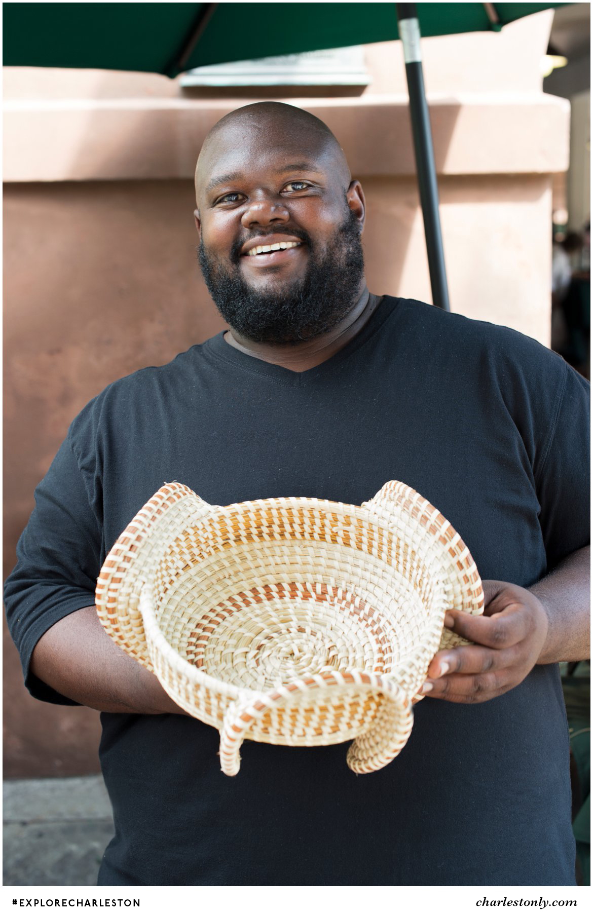 Corey Alston holding a sweetgrass basket that he made